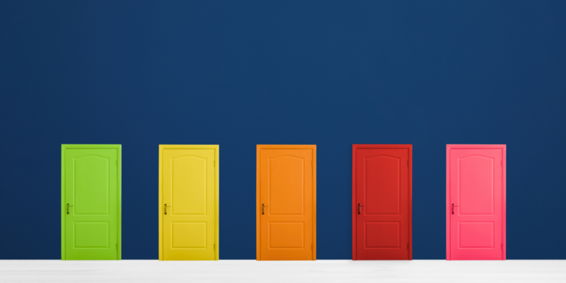 Five doors sit against a dark blue backdrop with a lime green, yellow, orange, red, and pink door from left to right.